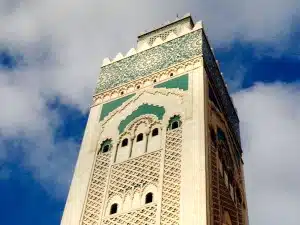 stone minaret, green, blue, blue sky