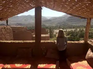 tourist viewing ruins from atop a kasbah