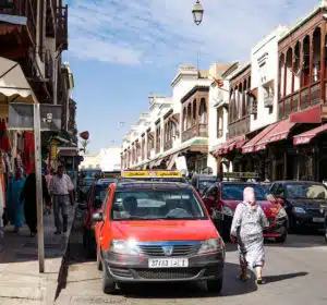 Busy street with taxis in Morocco, illustrating tipping culture for taxi services.