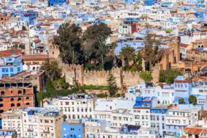 View of the blue-washed city of Chefchaouen with its blue and white buildings. Perfect for a picturesque stop on our North to South tour of Morocco.