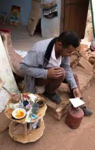 A Morrocan man Abdou selling hand-painted art and postcards from Morocco