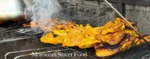 Street vendor preparing a traditional Moroccan tagine, showcasing the vibrant street food culture in Morocco.