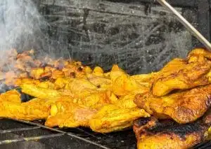 Street vendor preparing a traditional Moroccan tagine, showcasing the vibrant street food culture in Morocco.