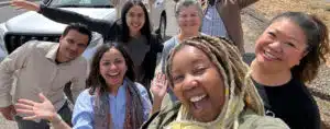 a group of smiling tourists posing for a selfie picture taken by one of them while visiting Morocco