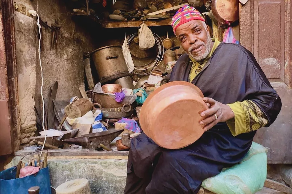 Hamid, one of the skilled artisans of Seffarine Square in Fes, at work
