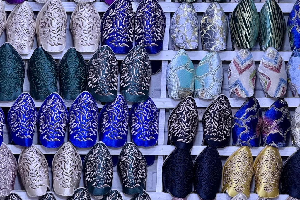 rows of colorful Moroccan slippers (babouches) on a display in the slipper market of Kissariat al Kifah