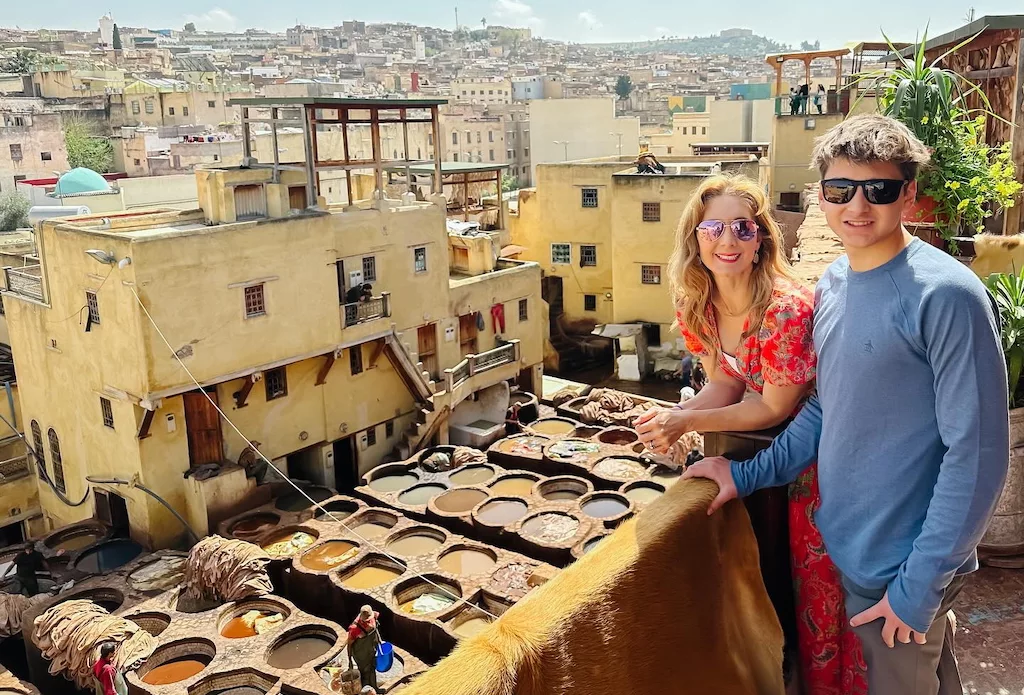 a couple standing on a balcony overlooking the leather tannery in Souk Jeld in Fes