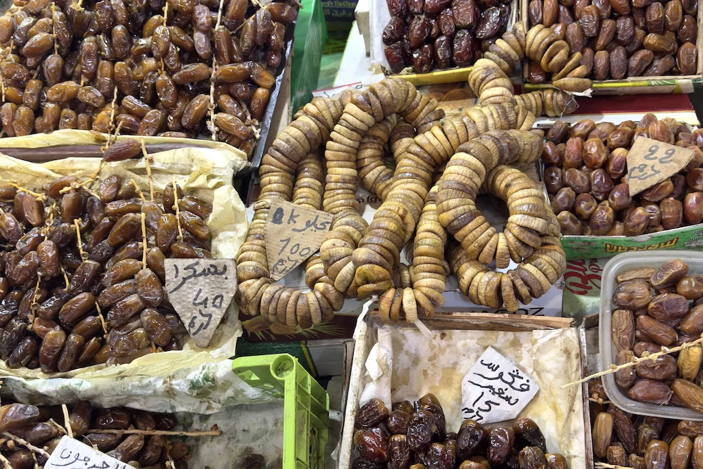 dried figs and dates in boxes on display in Souk Al-Attarine