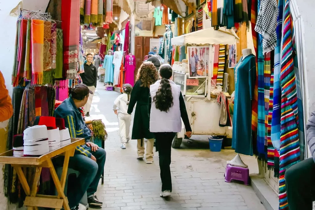 tourists walking through one of the souks of Fes on their guided tour with Open Doors Morocco