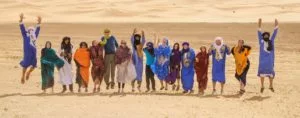 the whole Open Doors Morocco team gathered in the desert and jumping up while posing for the picture
