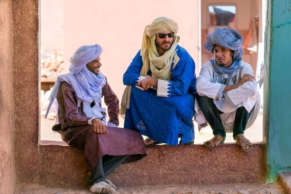 three of our local guides in Open Doors Morocco hanging out together and smiling at the camera