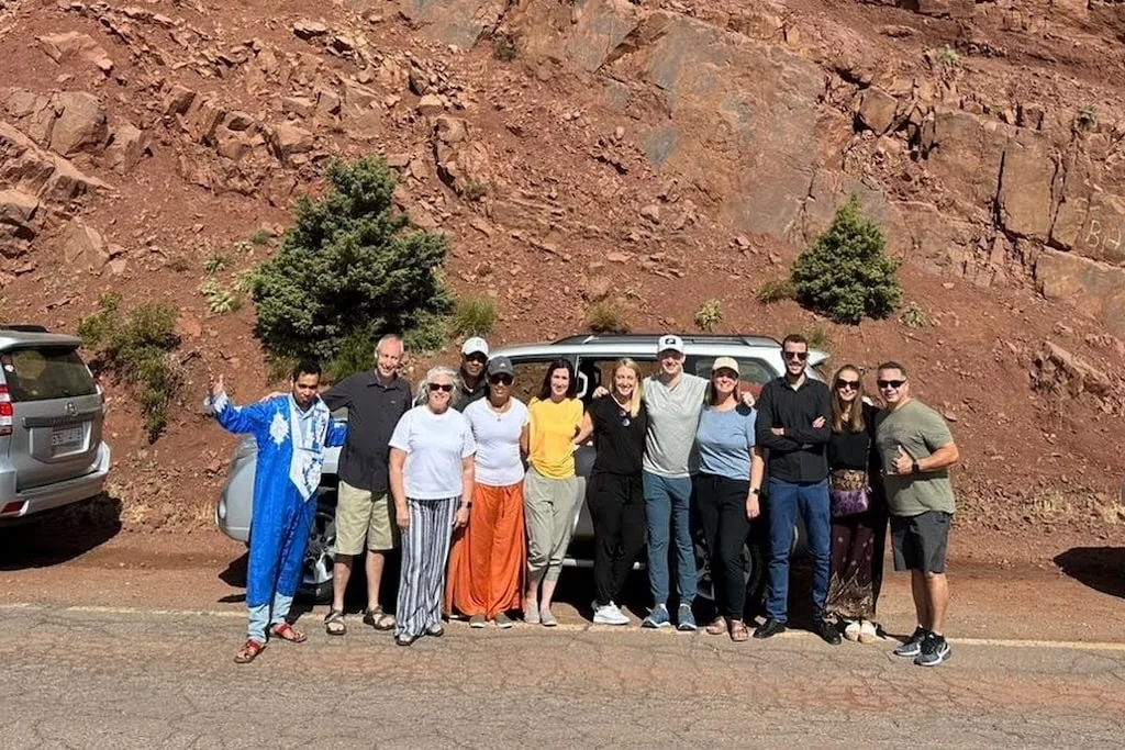 a group of travelers in Morocco taking a group picture together with their local guides from Open Doors Morocco