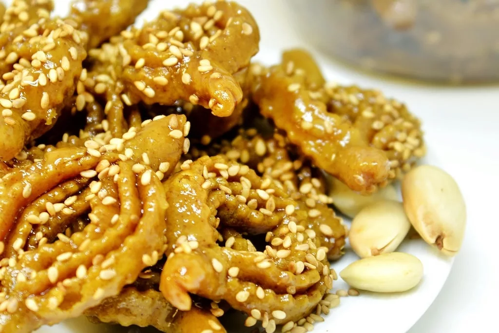 a close up of a table full of chebakia, a traditional Moroccan honey-soaked pastry served during Ramadan