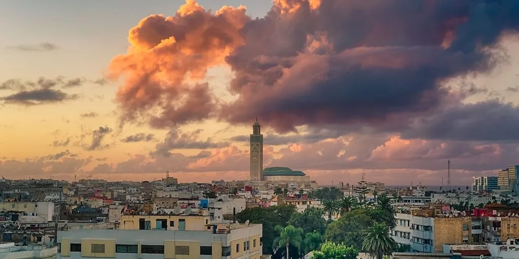 the Hassan Mosque dominating the horizon with dramatic clouds in the background