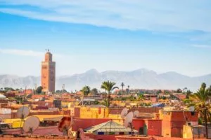 a panoramic view of Marrakech, one of Morocco's imperial cities, with the tower of the Koutoubia Mosque dominating the view