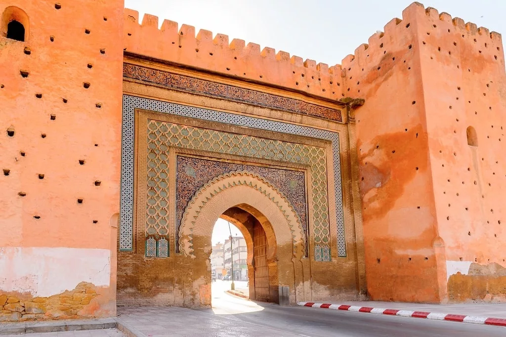 the Gate of Bab Mansour in Meknes with colorful tiles lining the entrance