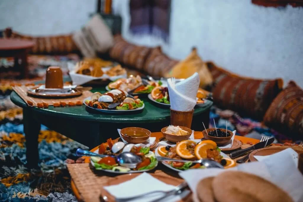 Two tables with traditional Moroccan food that you can try in the Moroccan Culinary Arts Museum in Marrakech.