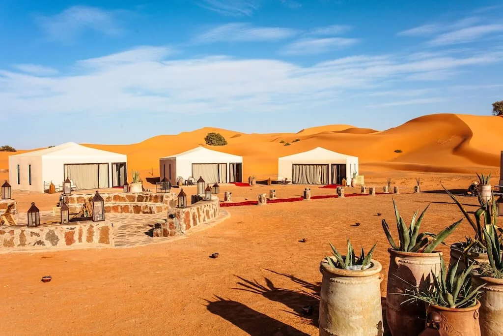 If you were wondering where to stay in Morocco, desert camps are a one-of-a-kind experience. The Luxury Camp in Merzouga is one of our favorite ones, with comfortable tents set right in between the dunes.