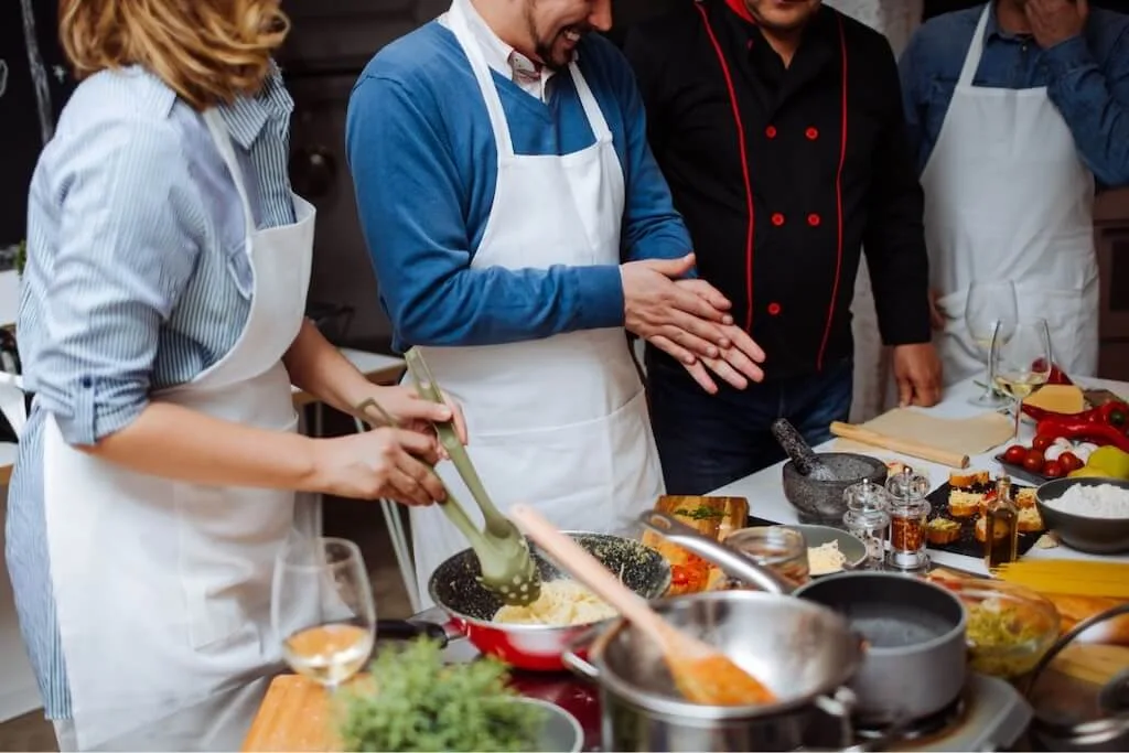 A couple sharing a Moroccan cooking class as a part of their romantic Morocco itinerary.