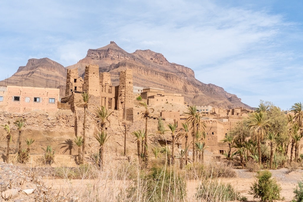 a 16th-century Kasbah des Caids in Tamnougalt seen from the outside with a mountain in the background