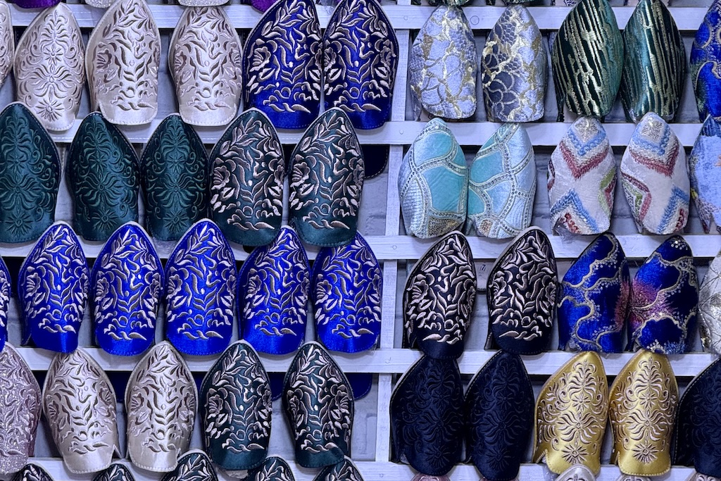 rows of colorful Moroccan slippers (babouches) on a display in the slipper market of Kissariat al Kifah