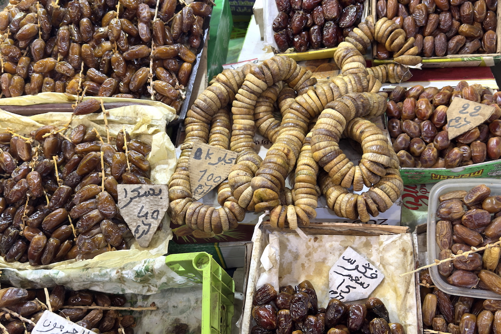 dried figs and dates in boxes on display in Souk Al-Attarine