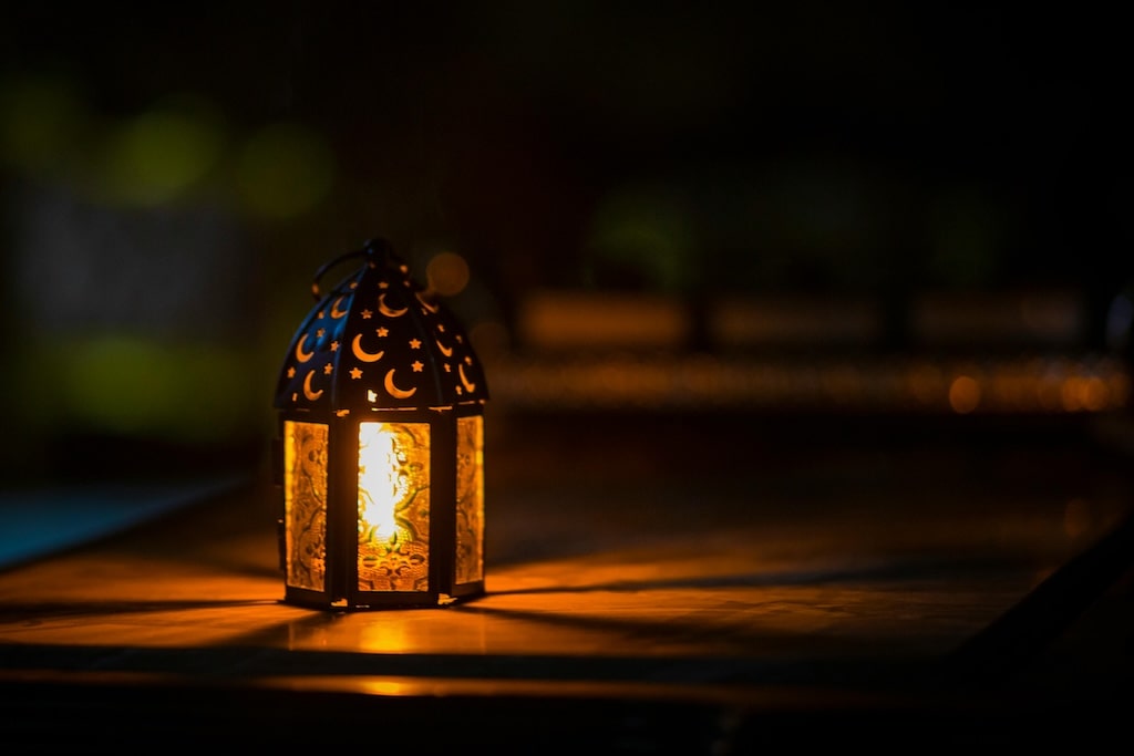 a lantern with crescent moon and stars symbols in the top with a candle burning inside, a typical symbol of the coming Ramadan in Morocco