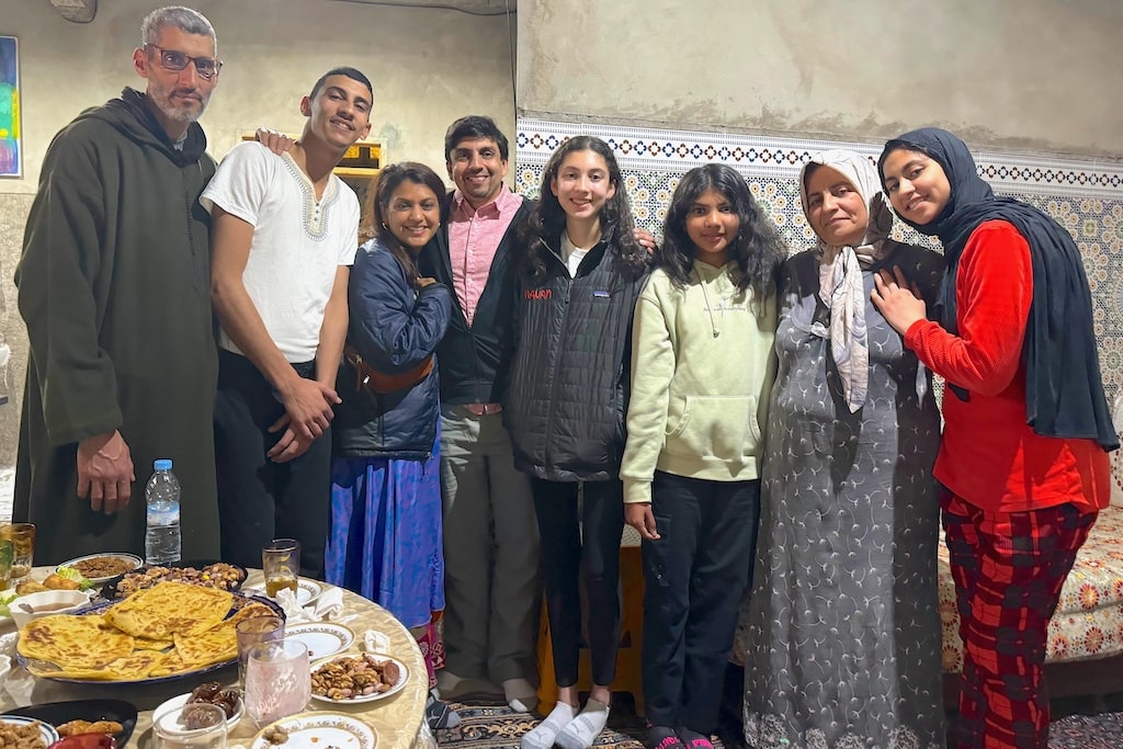 a local Moroccan family posing for a picture right before breaking their fast with iftar during Ramadan in Morocco