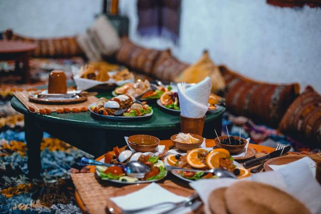 Two tables with traditional Moroccan food that you can try in the Moroccan Culinary Arts Museum in Marrakech.